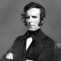 John Simmons, posed with arms folded across his chest.