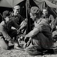 Captain Beatrice Parker '34 posed interviewing soldiers near their tents in Rome, Italy