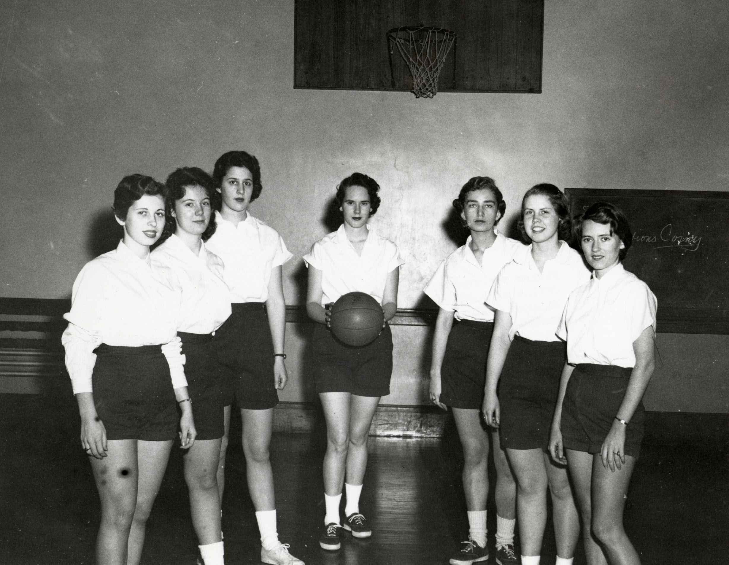 Basketball team posing in Old Gym (1950s) · Sports@Simmons