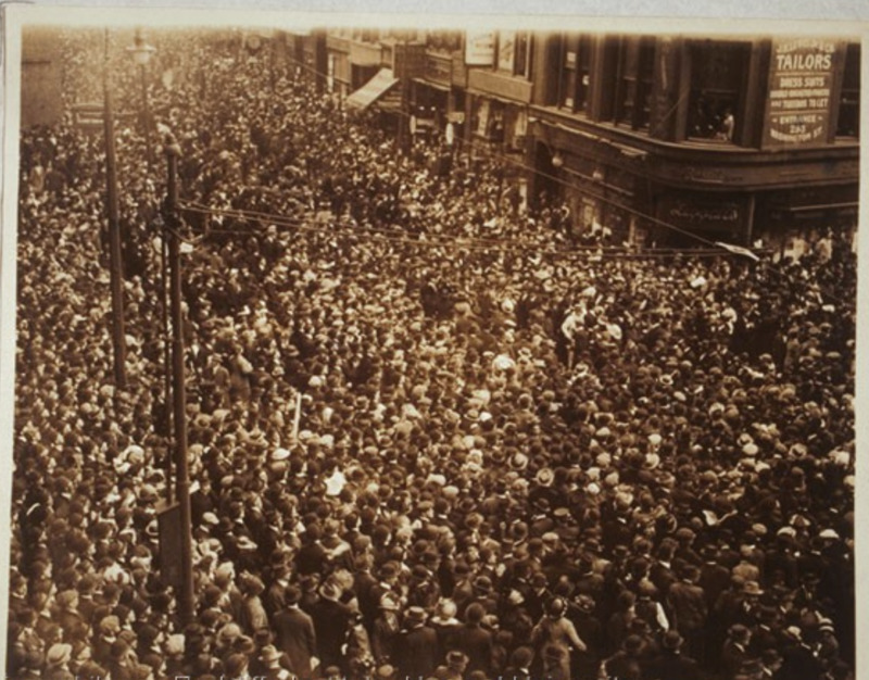Aerial view of the corner of Washington and School streets, packed tightly with people.
